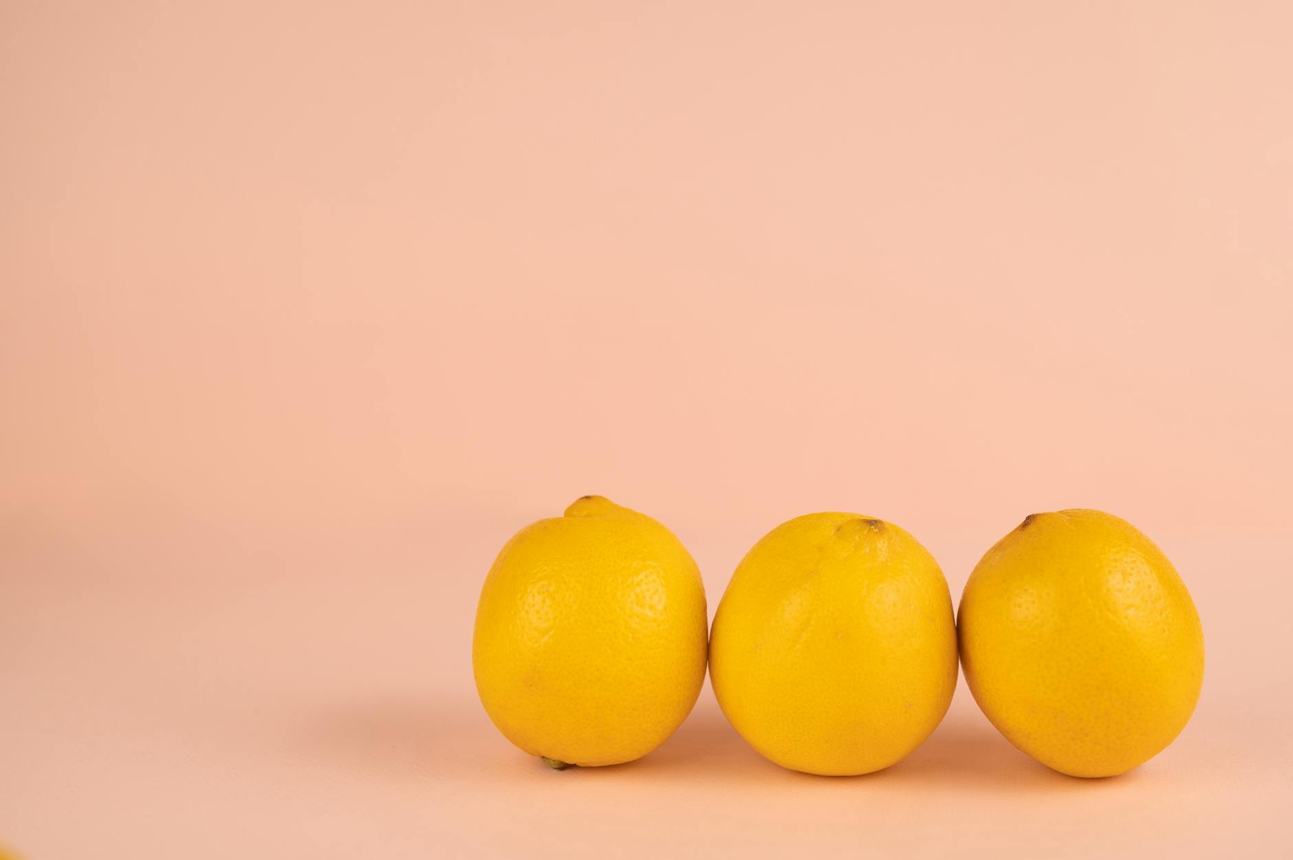 Yellow silicone clitoral vibrator surrounded by fresh bananas on a bright yellow background